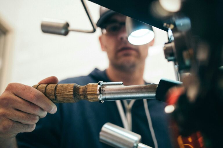 Worker using industrial machine tool with wooden handle