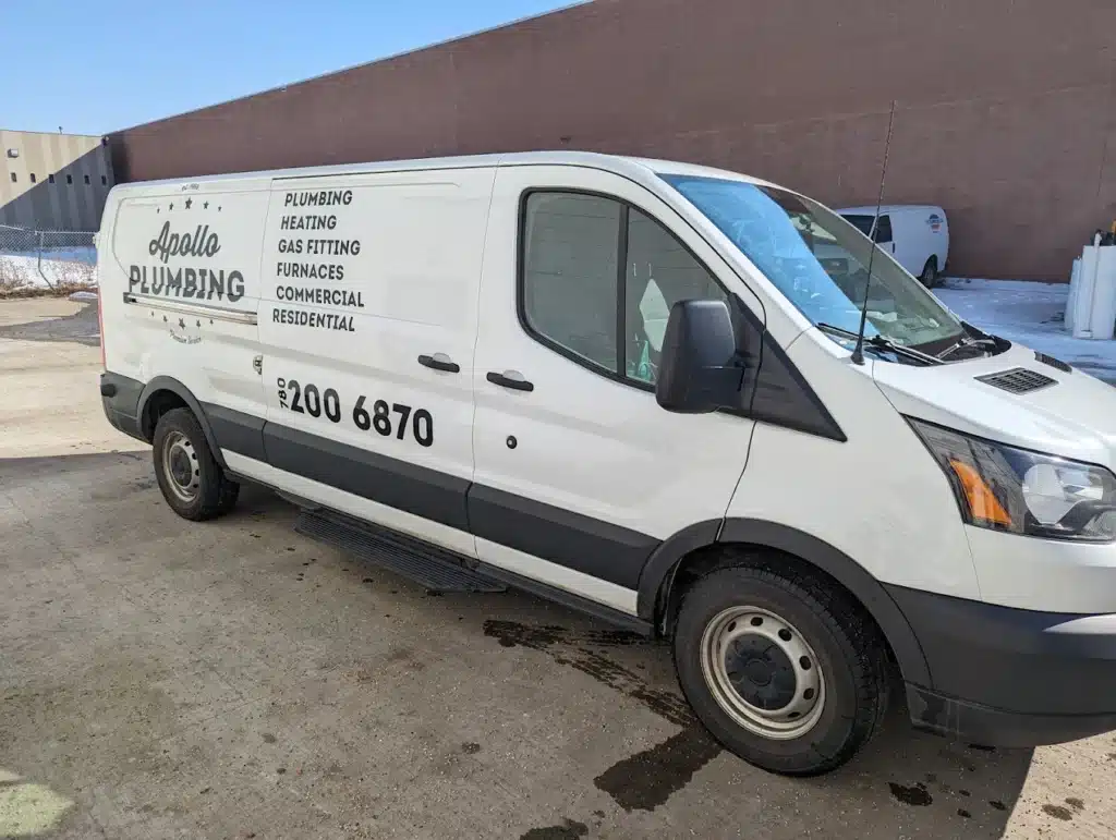 White Apollo Plumbing service van parked outdoors