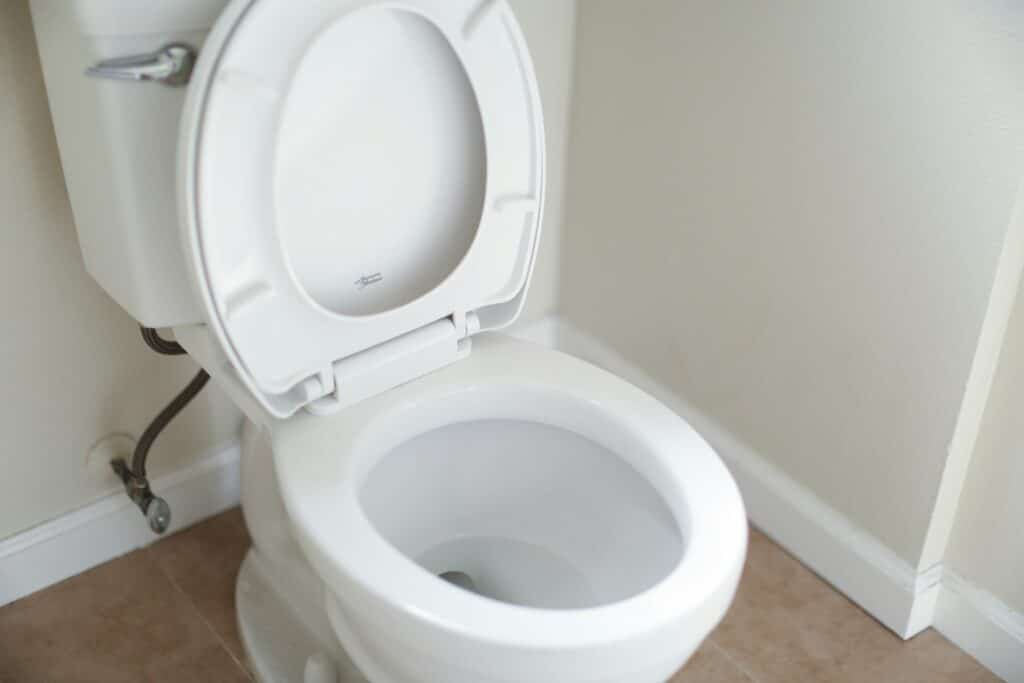 White toilet with seat and lid raised